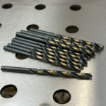 Black and gold HSS Jobber drill bits laying on welding table