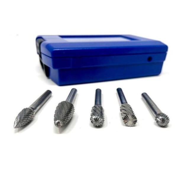 Set of tungsten carbide rotary burr bits displayed beside a blue plastic storage case on a white background