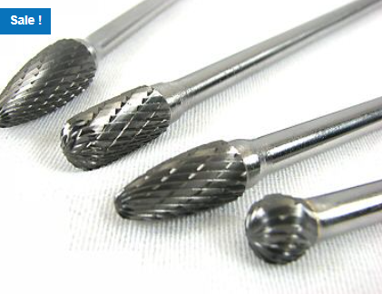 Four carbide rotary burr bits with textured cutting heads, shown close together on a white surface with a Sale label.